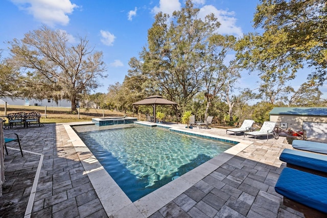 view of pool featuring a patio and an in ground hot tub