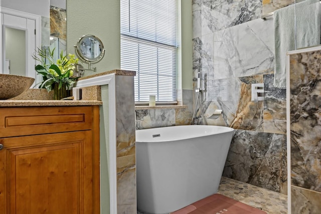 bathroom with vanity, shower with separate bathtub, and tile walls