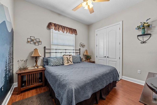 bedroom featuring hardwood / wood-style floors, a closet, and ceiling fan