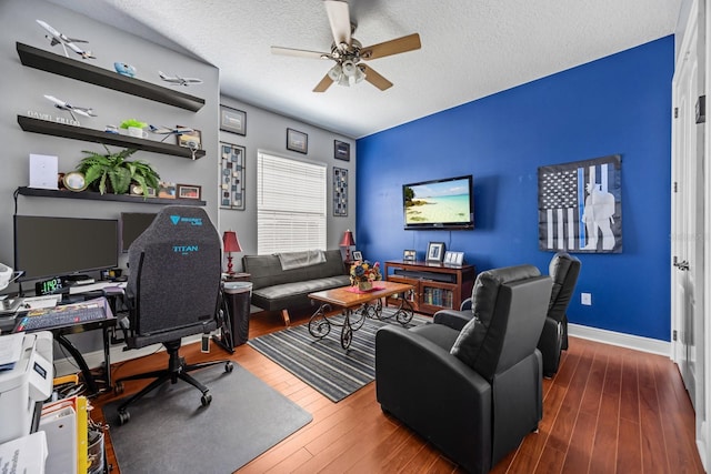 office area featuring ceiling fan, dark hardwood / wood-style floors, and a textured ceiling