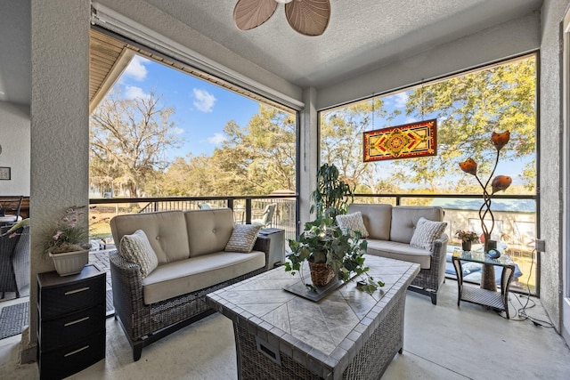 sunroom / solarium featuring ceiling fan