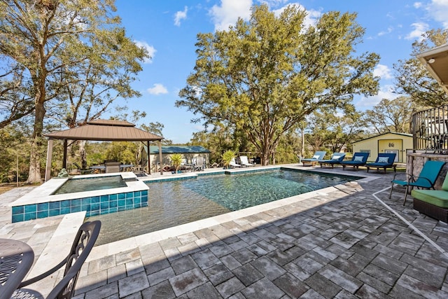 view of swimming pool with a gazebo, a patio area, and an in ground hot tub