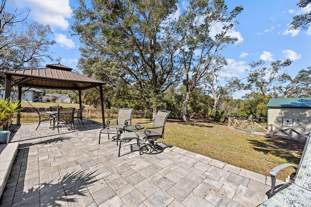 view of patio with a storage shed and a gazebo