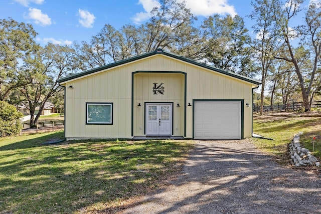 view of outdoor structure with a garage and a lawn