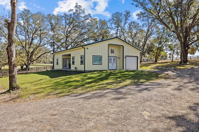 view of front of property with a garage and a front lawn