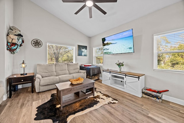 living room with lofted ceiling, light hardwood / wood-style floors, and ceiling fan