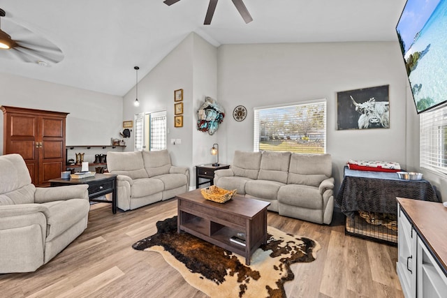 living room featuring high vaulted ceiling, light hardwood / wood-style floors, and ceiling fan