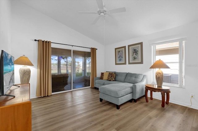 living room featuring lofted ceiling, hardwood / wood-style floors, and ceiling fan