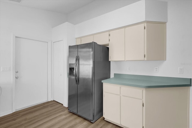 kitchen featuring stainless steel refrigerator with ice dispenser and light wood-type flooring