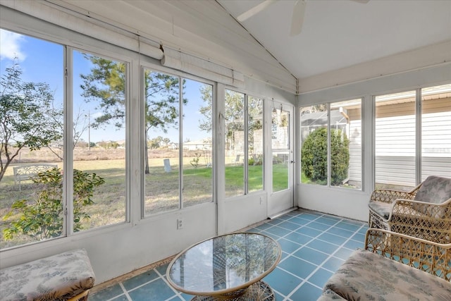 sunroom / solarium with lofted ceiling and ceiling fan