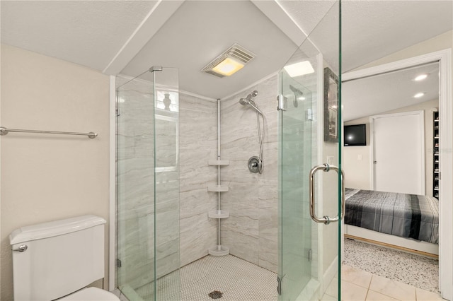 bathroom featuring visible vents, toilet, a stall shower, ensuite bathroom, and lofted ceiling