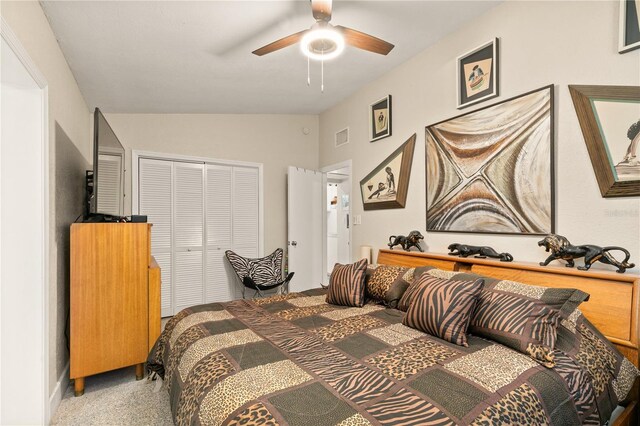 bedroom featuring a closet, visible vents, a ceiling fan, and vaulted ceiling