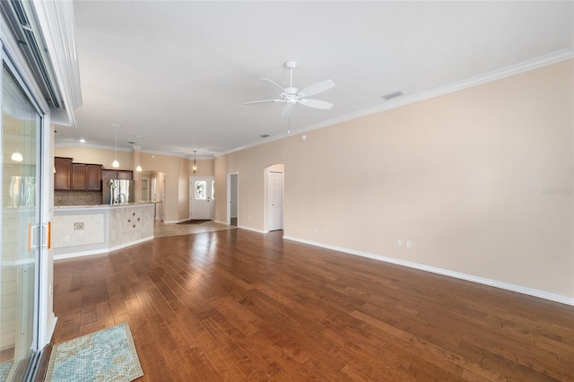 unfurnished living room with ornamental molding, dark hardwood / wood-style floors, and ceiling fan