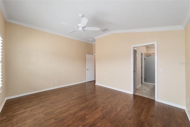 empty room with ornamental molding, vaulted ceiling, ceiling fan, and dark hardwood / wood-style flooring