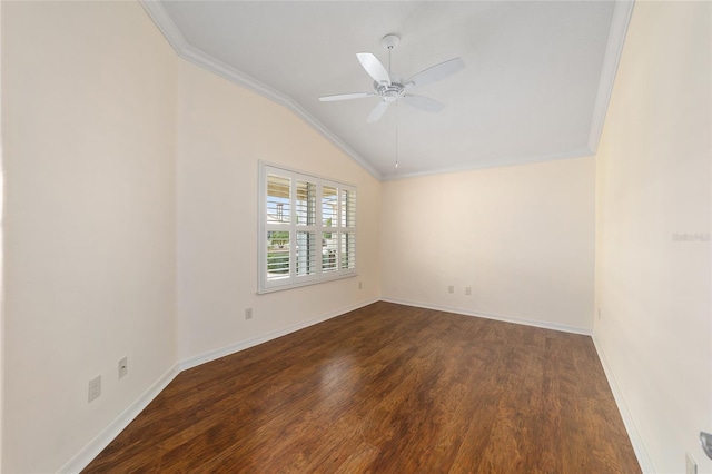 empty room with ornamental molding, vaulted ceiling, dark hardwood / wood-style floors, and ceiling fan