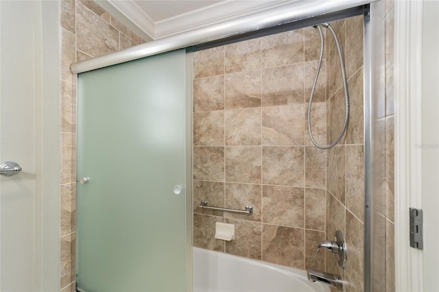 bathroom featuring ornamental molding and bath / shower combo with glass door