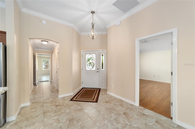 foyer featuring crown molding