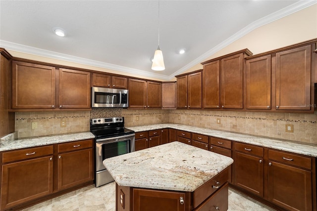 kitchen featuring vaulted ceiling, appliances with stainless steel finishes, light stone counters, and decorative light fixtures