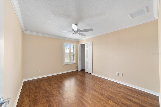 unfurnished room with ornamental molding, dark wood-type flooring, ceiling fan, and a textured ceiling