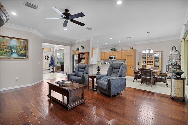 13914 SE 96th Cir, Summerfield, FL 34491 - living room featuring wood-type flooring, ceiling fan with notable chandelier, and crown molding