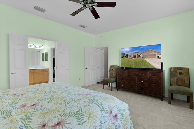 13914 SE 96th Cir, Summerfield, FL 34491 - bedroom featuring ceiling fan, connected bathroom, and light carpet