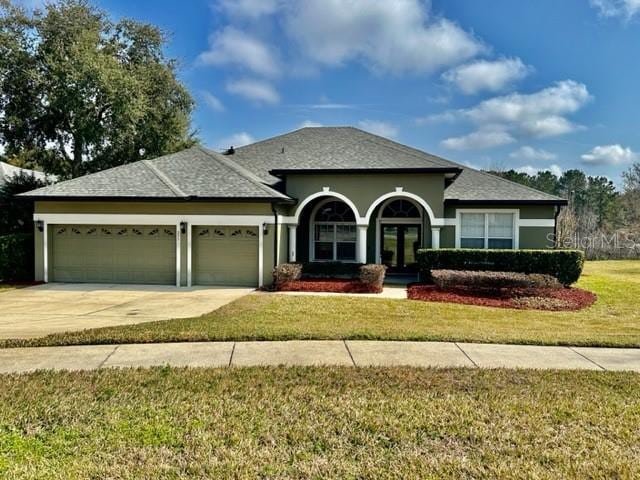 view of front of house with a garage and a front yard