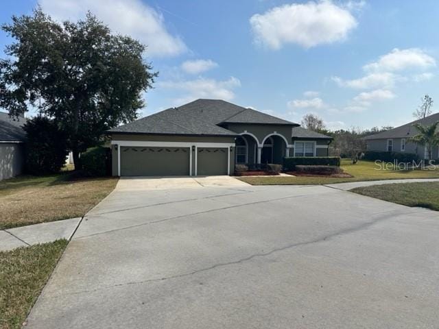 view of front facade with a garage and a front lawn