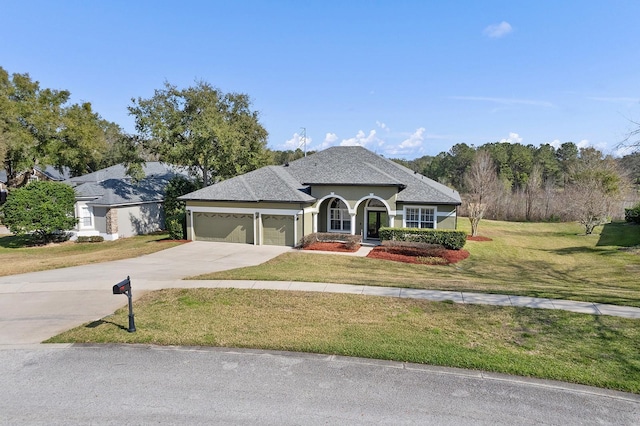 view of front facade with a garage and a front lawn