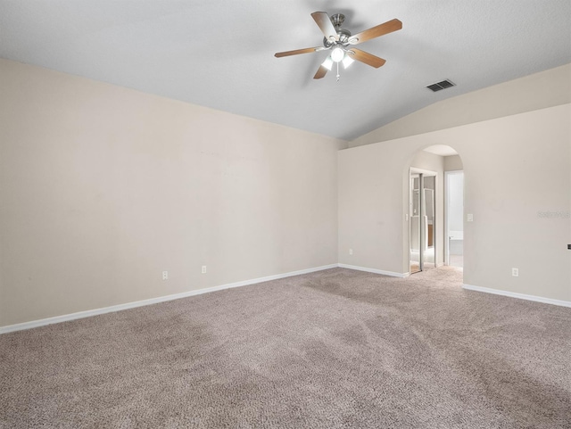 unfurnished room featuring carpet floors, vaulted ceiling, and ceiling fan