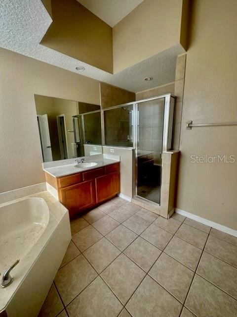 bathroom with vanity, tile patterned floors, and plus walk in shower