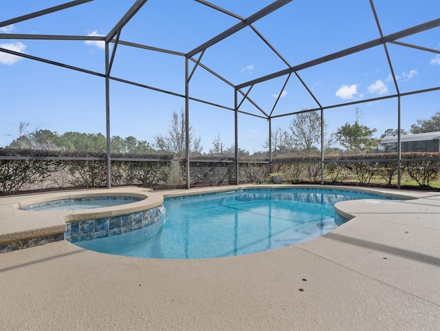 view of swimming pool featuring an in ground hot tub, a patio, and glass enclosure