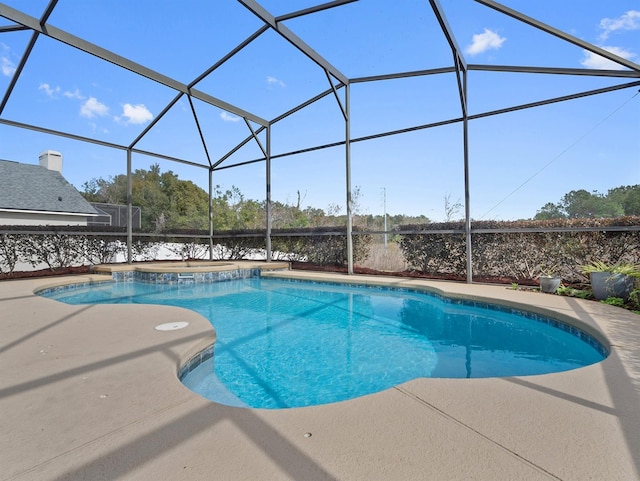 view of swimming pool with a patio and glass enclosure