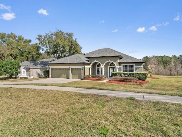 view of front of home with a garage and a front lawn