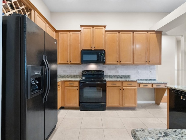 kitchen featuring light stone counters, light tile patterned floors, tasteful backsplash, and black appliances