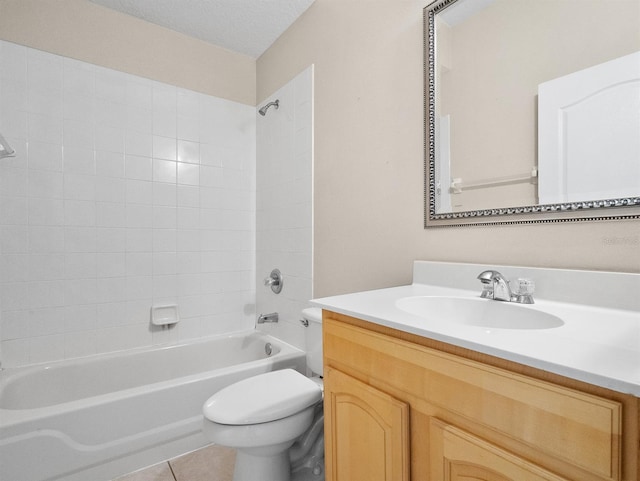 full bathroom with tile patterned floors, toilet, a textured ceiling, vanity, and tiled shower / bath combo