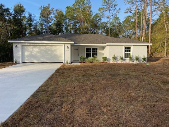 ranch-style house featuring a garage and a front lawn