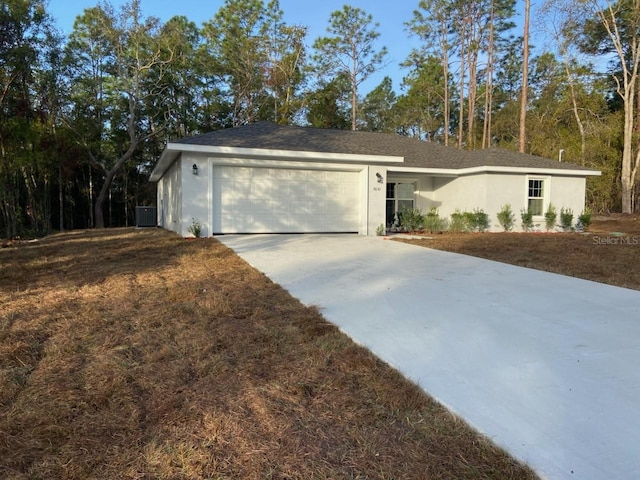 ranch-style home with a garage and a front lawn