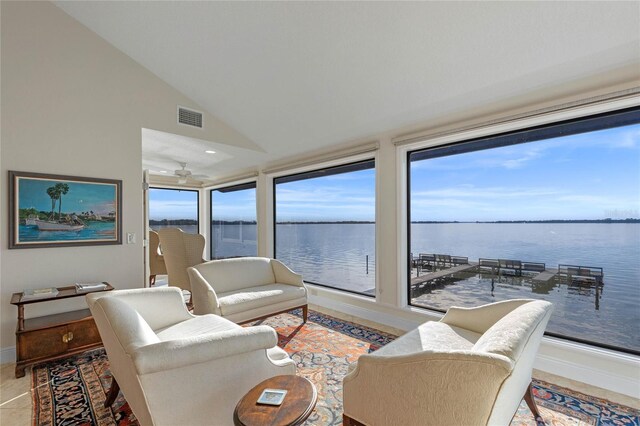 living room with a water view and vaulted ceiling