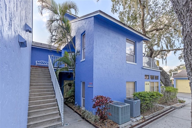 view of home's exterior featuring a balcony and central air condition unit