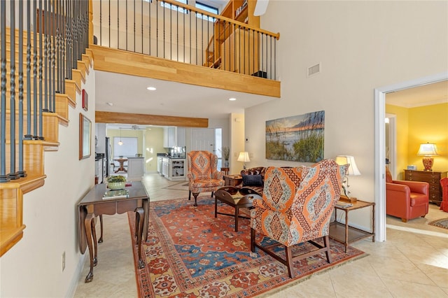 living room featuring light tile patterned floors and a towering ceiling