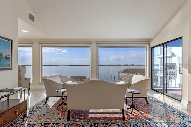 sunroom / solarium with lofted ceiling and a water view