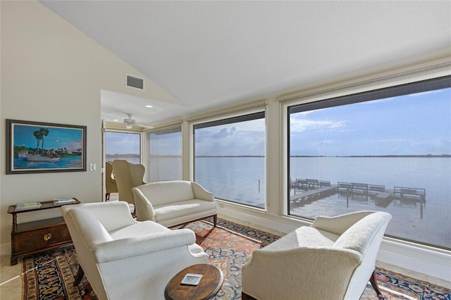 living room featuring a water view, lofted ceiling, and a wealth of natural light