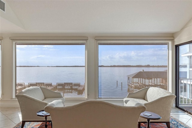 sunroom / solarium with a water view and vaulted ceiling