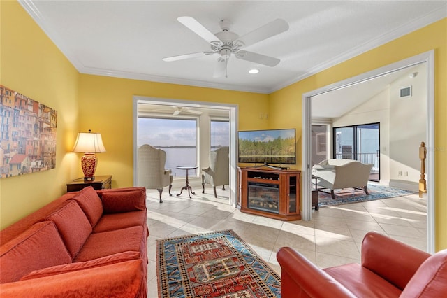 living room featuring light tile patterned flooring, ceiling fan, and crown molding