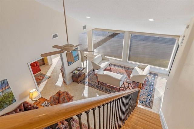 stairs featuring tile patterned flooring and ceiling fan