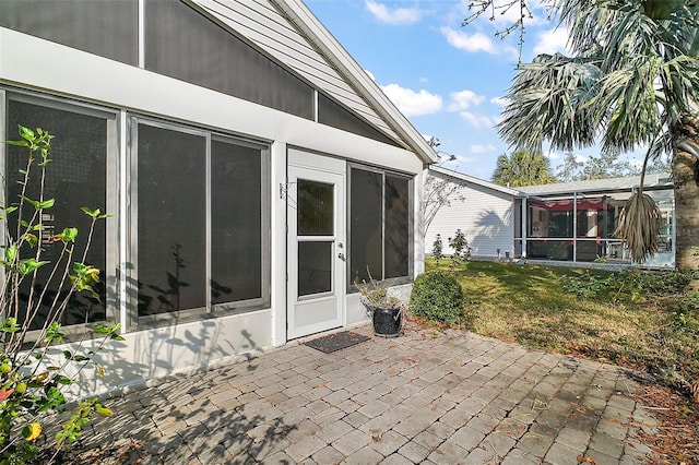 view of patio / terrace featuring a sunroom