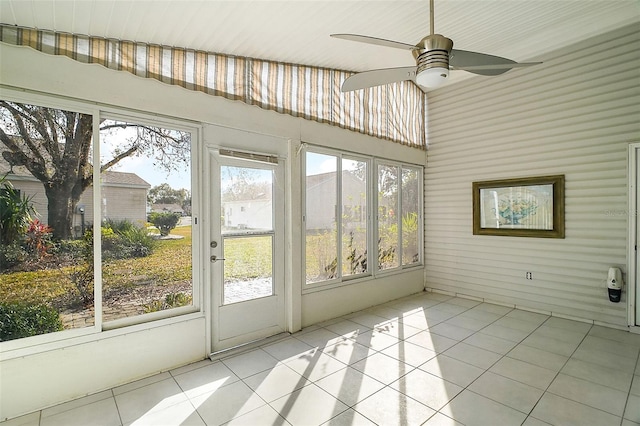 unfurnished sunroom with vaulted ceiling and ceiling fan