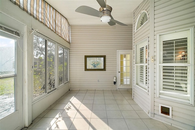 unfurnished sunroom with ceiling fan