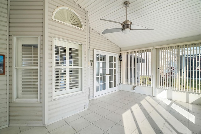 unfurnished sunroom with lofted ceiling and ceiling fan