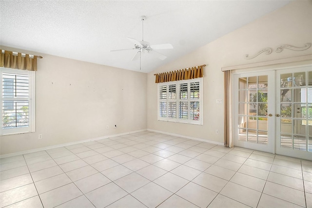 tiled empty room featuring lofted ceiling, a textured ceiling, french doors, and ceiling fan